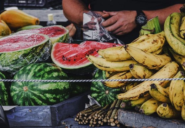 person holding banana fruit and watermelon