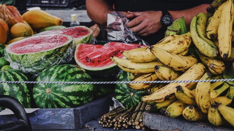 person holding banana fruit and watermelon